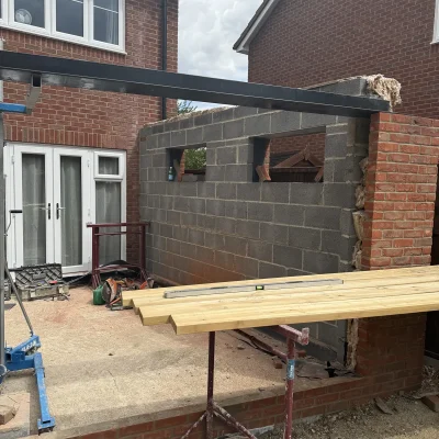 Structural steel and masonry during construction of a rear extension in Highfields Caldecote