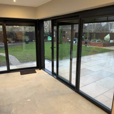 Interior view through aluminium sliding doors towards the garden
