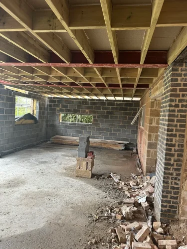 Timber first-floor joists installed inside the two-storey extension.