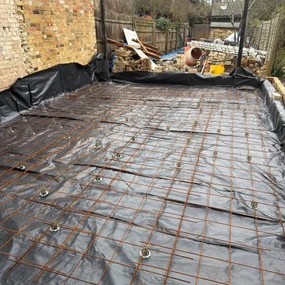 Steel reinforcement mesh laid over a damp-proof membrane ready for a concrete slab in Cambridge