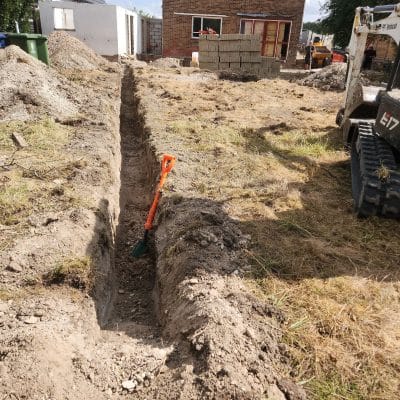 Excavator digging foundation trenches for an extension at Hinton Way, Great Shelford