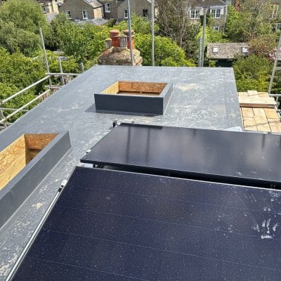 New single ply flat roof with parapet upstands on a rear extension in Cambridge