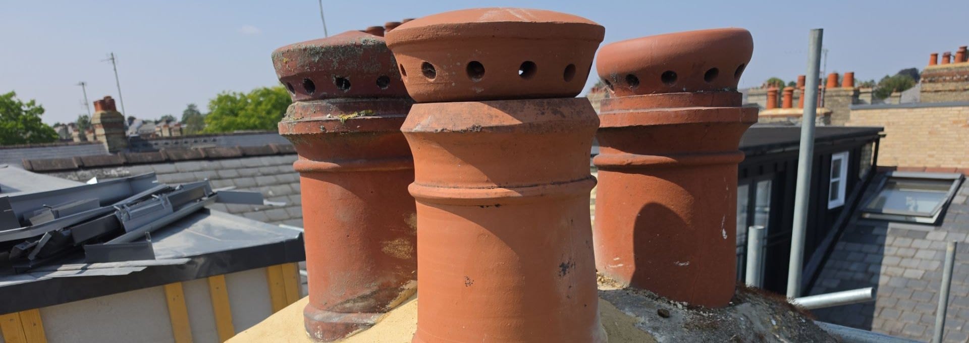 Rebuilt chimney stack with new pots and flaunching above Cambridge rooftops